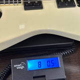 Used Jackson Custom Shop TSG SL2H Illuminati Vanilla Shake on scale.