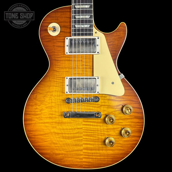 Electric guitar with a sunburst finish on a black background, featuring the Tone Shop logo.