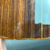 Close-up of a wooden surface with visible wear and tear against a blue background