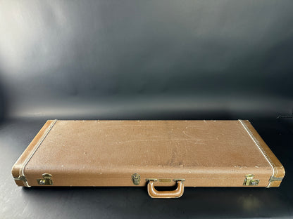 Brown vintage suitcase on a dark background