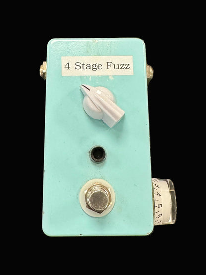 Light blue guitar effects pedal labeled '4 Stage Fuzz' on a textured surface