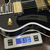 Electric guitar on a digital scale displaying weight