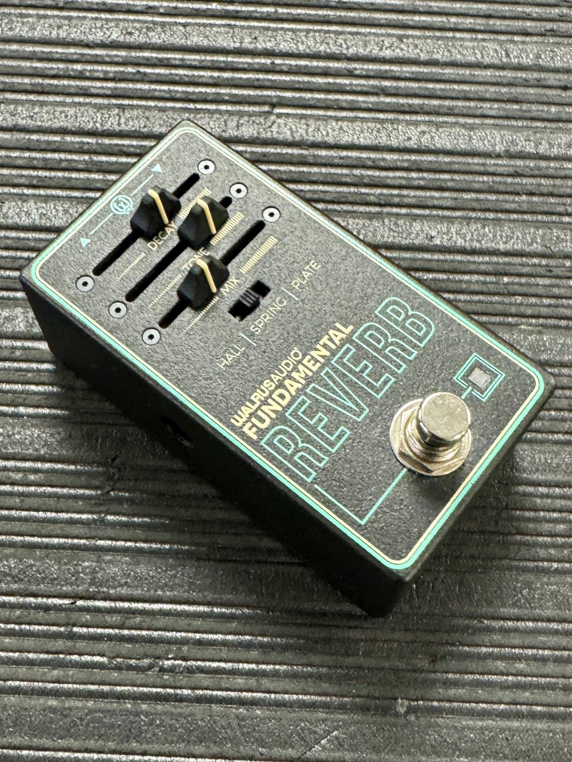 Electronics pedal with 'Fundamental Reverb' branding on a textured surface