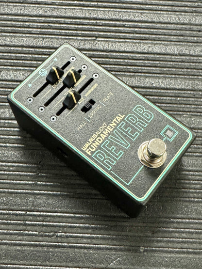 Electronics pedal with 'Fundamental Reverb' branding on a textured surface