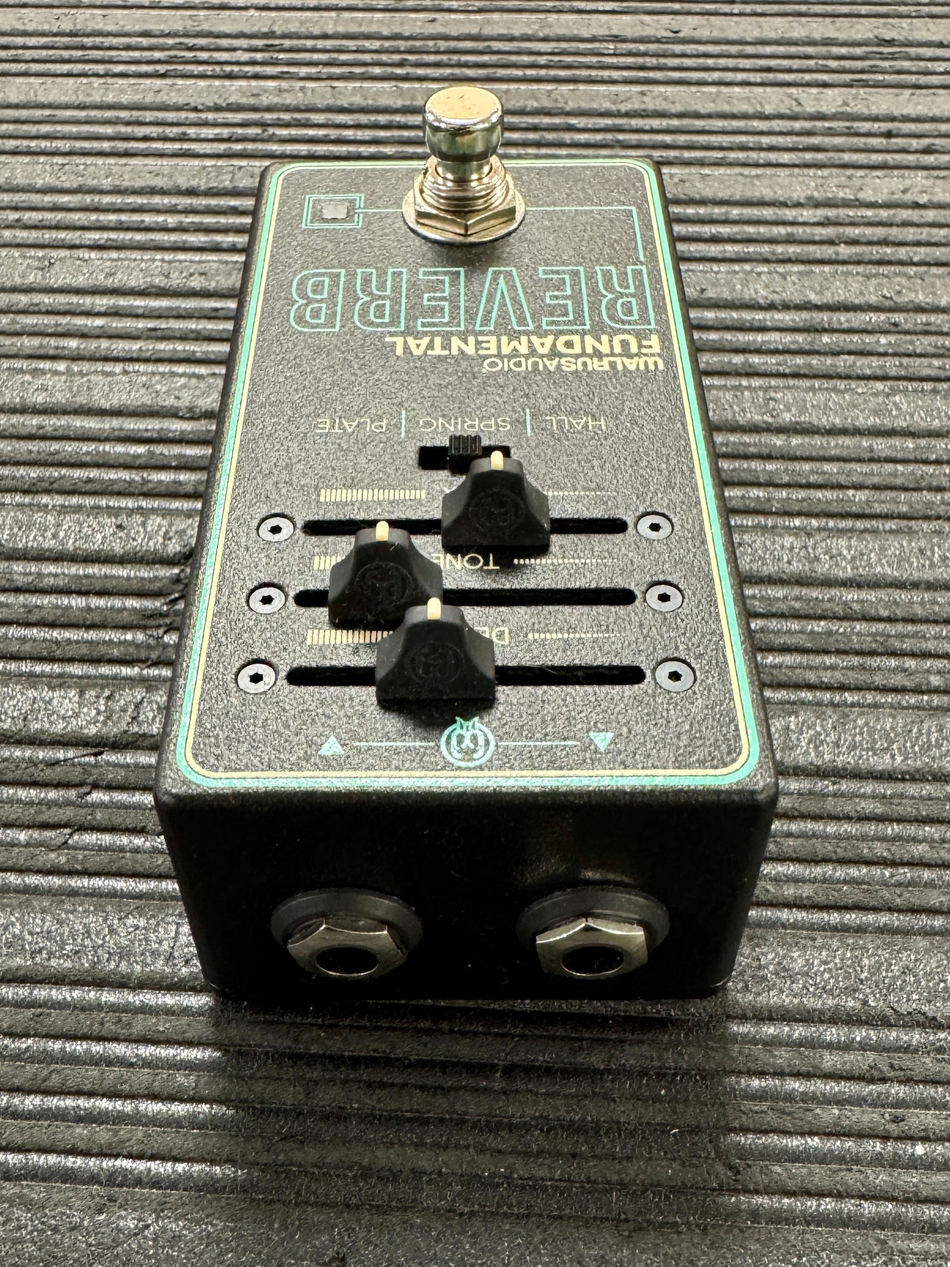 guitar effects pedal on a textured surface