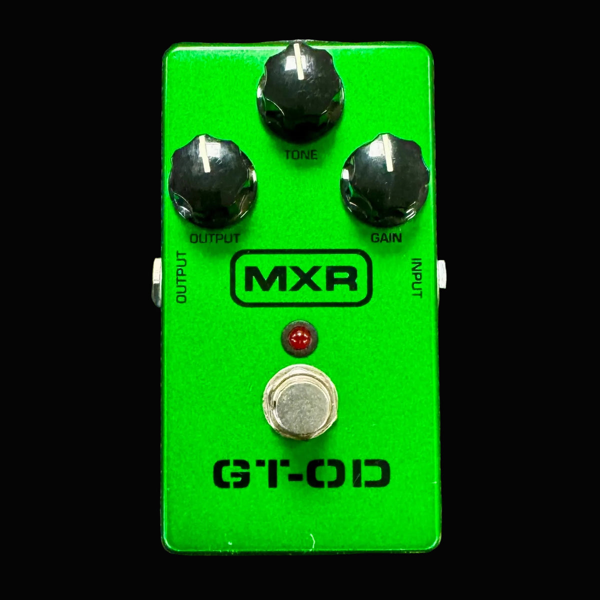 Green guitar effects pedal with MXR branding on a metallic background