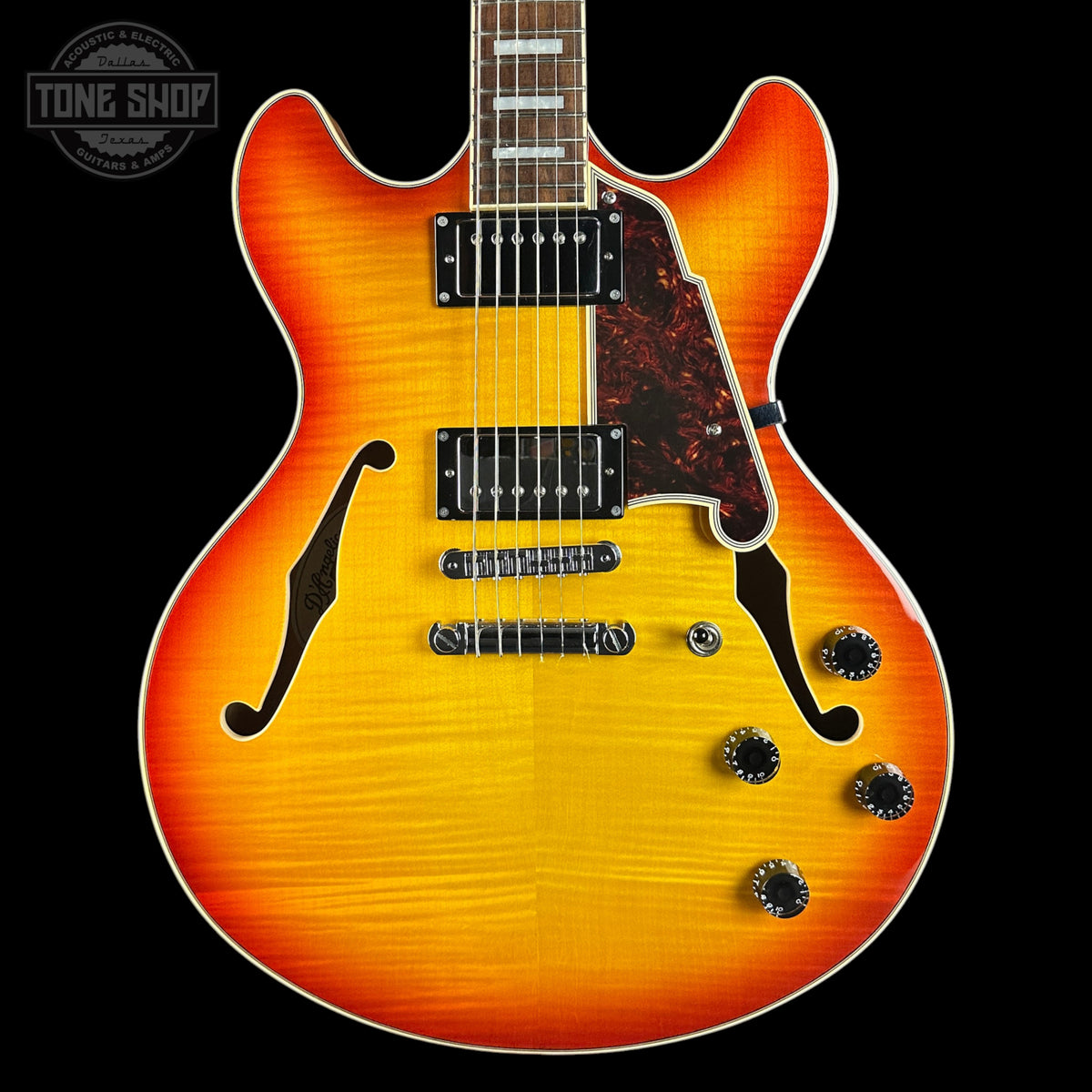 Electric guitar with a sunburst finish on a black background, featuring the Tone Shop logo.