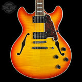 Electric guitar with a sunburst finish on a black background, featuring the Tone Shop logo.