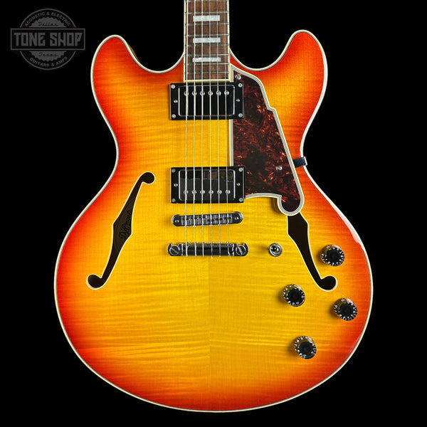 Electric guitar with a sunburst finish on a black background, featuring the Tone Shop logo.