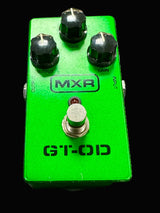 Green MXR GT-OD guitar effects pedal on a textured surface
