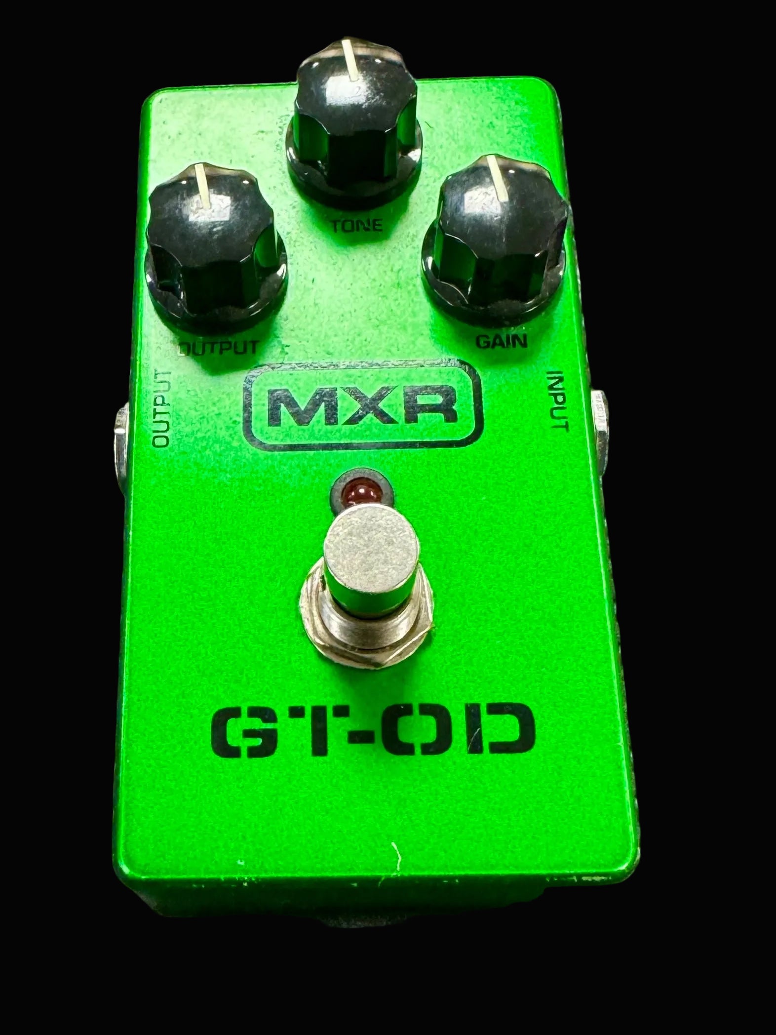 Green MXR GT-OD guitar effects pedal on a textured surface