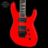 A bright red electric guitar shown from a front three-quarter angle against a solid black background, with a Tone Shop watermark in the top-left corner.