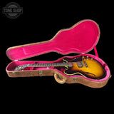 Guitar in a pink case with 'Tone Shop' logo in the corner