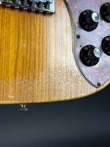 Close-up of a guitar's control panel with a dark background