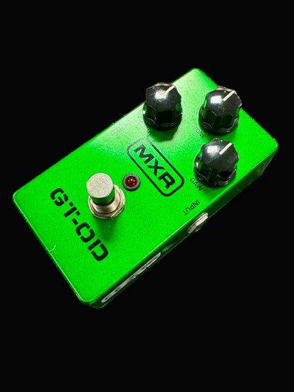 Green MXR guitar effects pedal on a textured surface