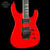 A bright red electric guitar with black hardware and a black neck, shown against a solid black background. A Tone Shop watermark is visible in the top-left corner.