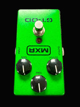 Green MXR guitar effects pedal on a textured surface