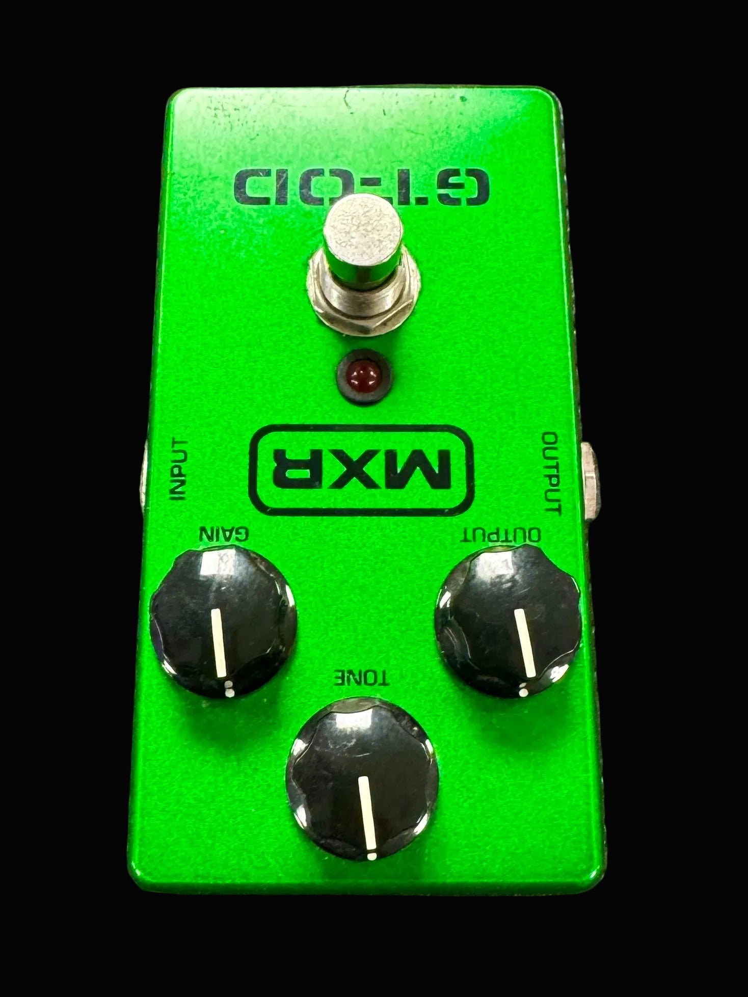 Green MXR guitar effects pedal on a textured surface
