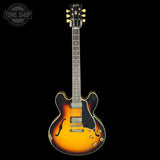 Gibson electric guitar with a sunburst finish on a black background