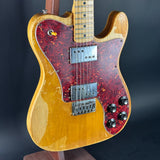 Electric guitar with a red flame pattern on a dark background