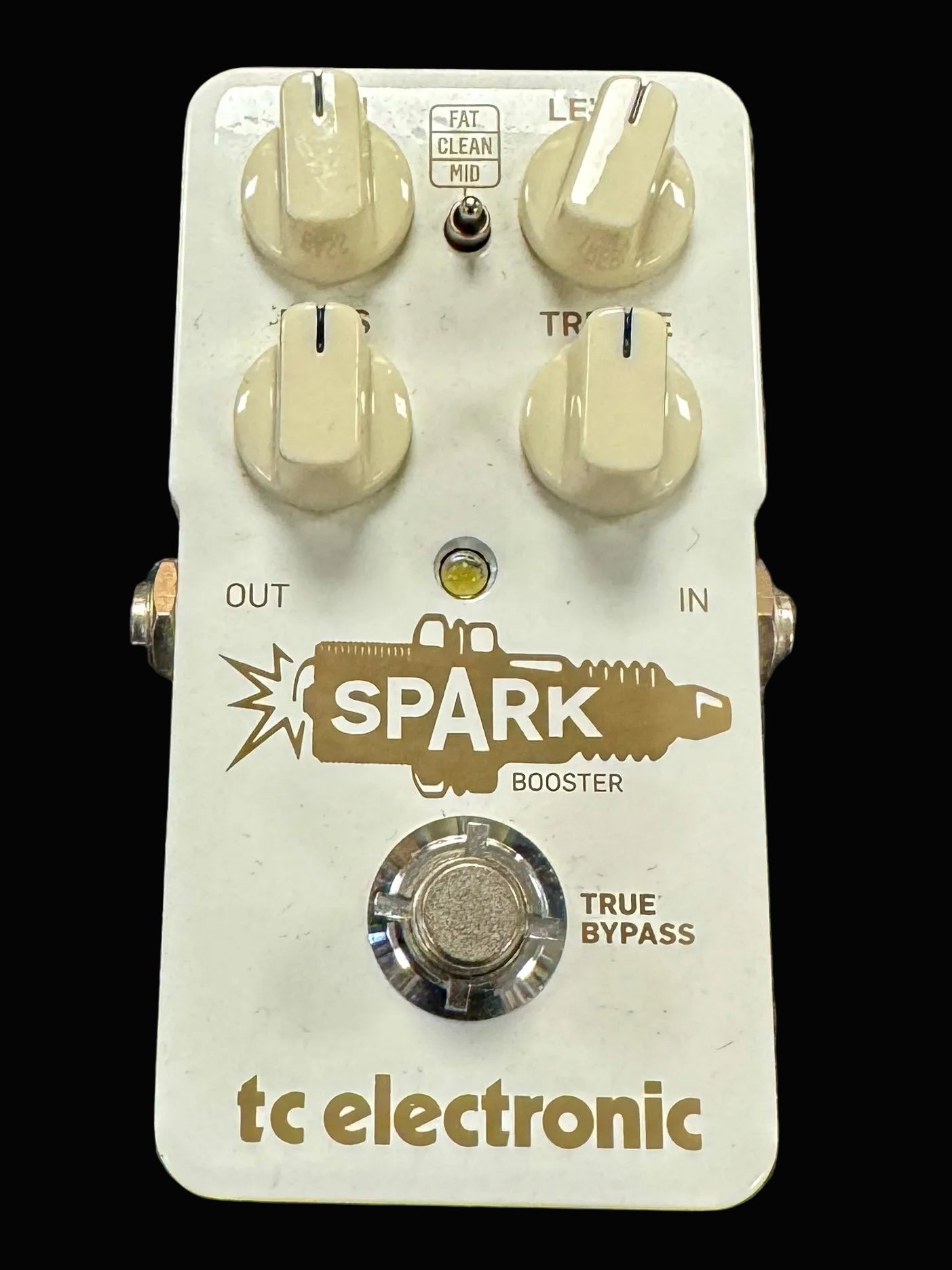 Guitar effects pedal with 'Spark Booster' branding on a textured surface