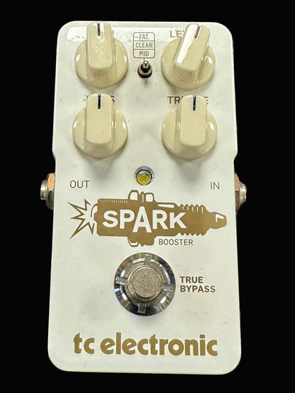 Guitar effects pedal with 'Spark Booster' branding on a textured surface