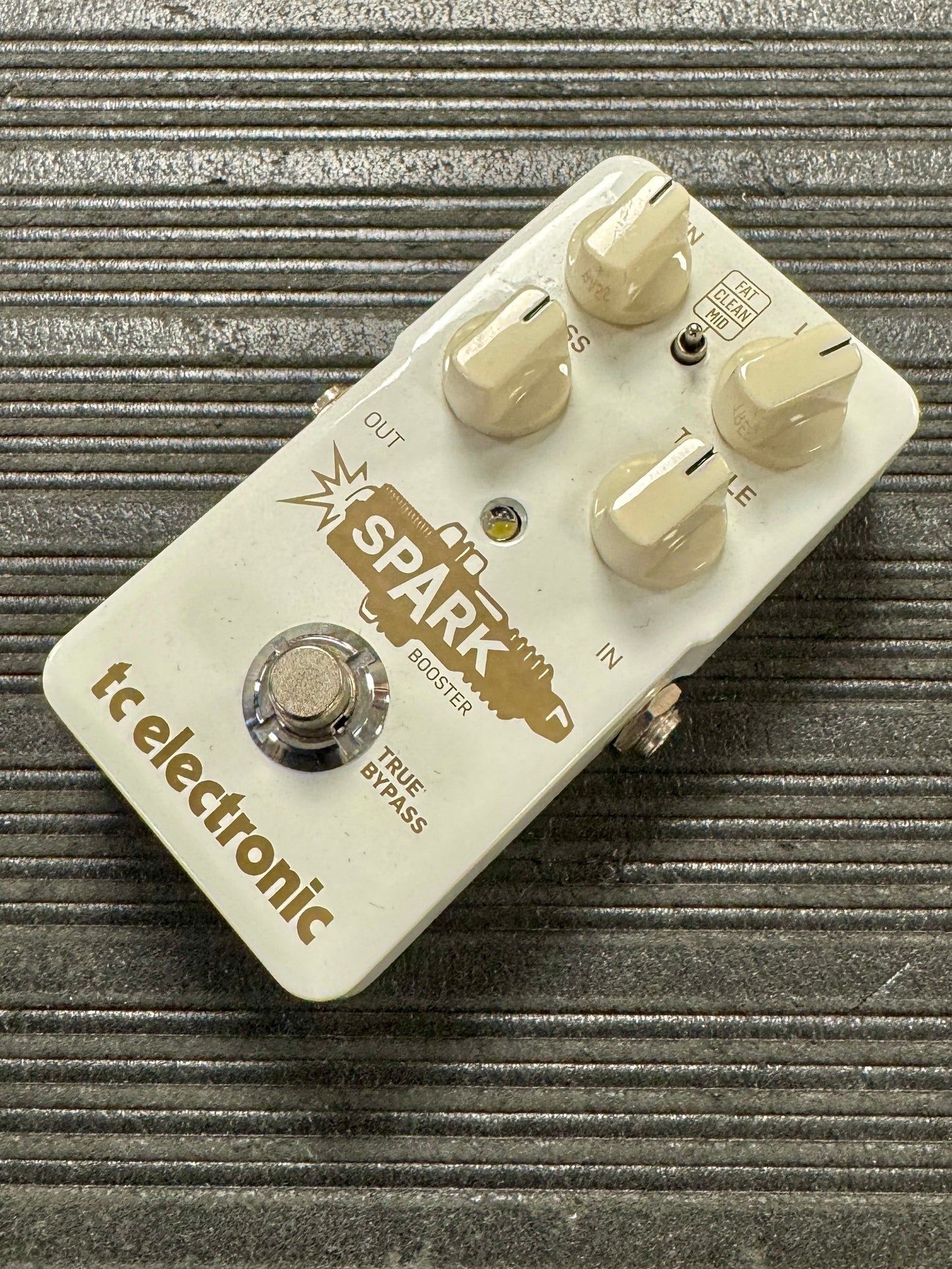 Guitar effects pedal with 'Spark' branding on a textured surface
