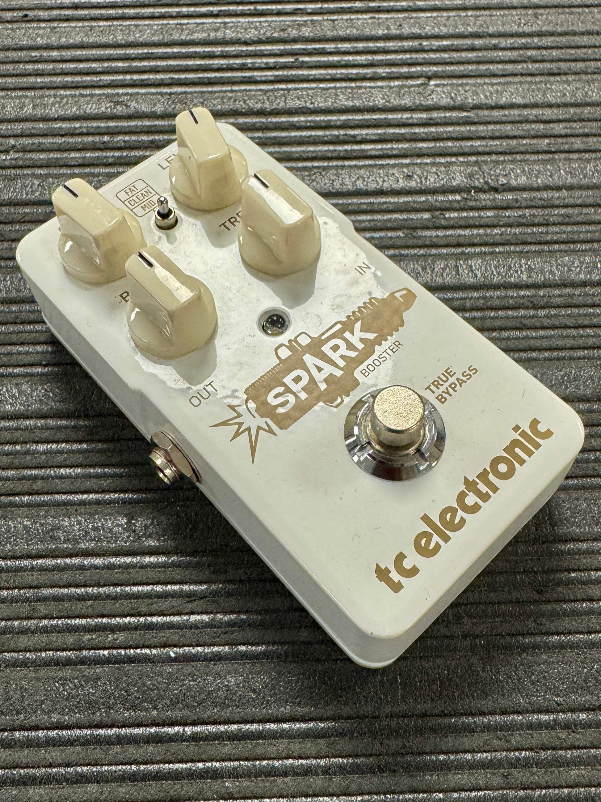 Guitar effects pedal with 'tc electronic' branding on a textured surface