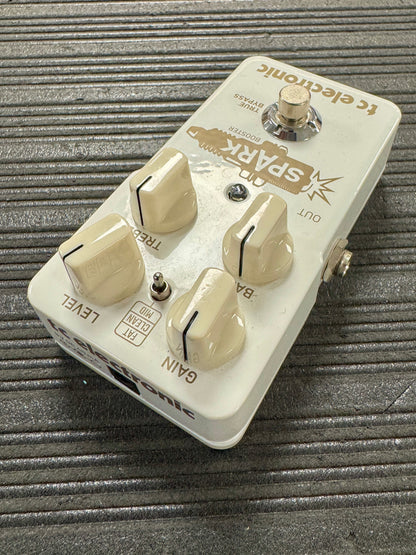 Guitar effects pedal with 'Spark' branding on a textured surface