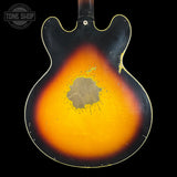 Back of a sunburst electric guitar with a visible brand logo in the corner.