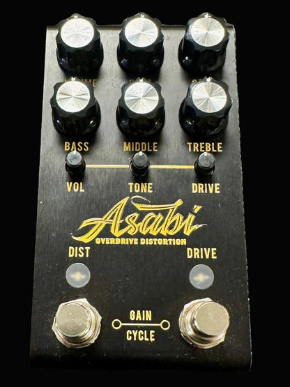 Guitar effects pedal with knobs and branding on a textured surface