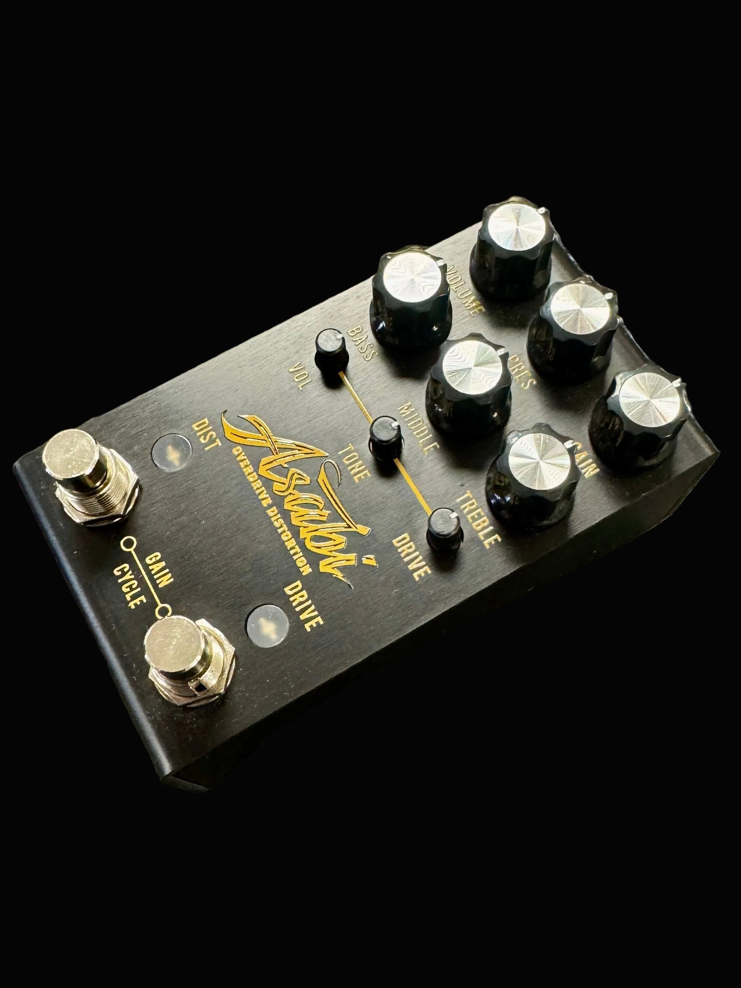Guitar effects pedal with multiple knobs on a textured surface