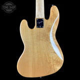 The back of a Fender Stratocaster electric guitar in natural maple wood finish, shown against a solid black background with a Tone Shop watermark in the top-left corner.
