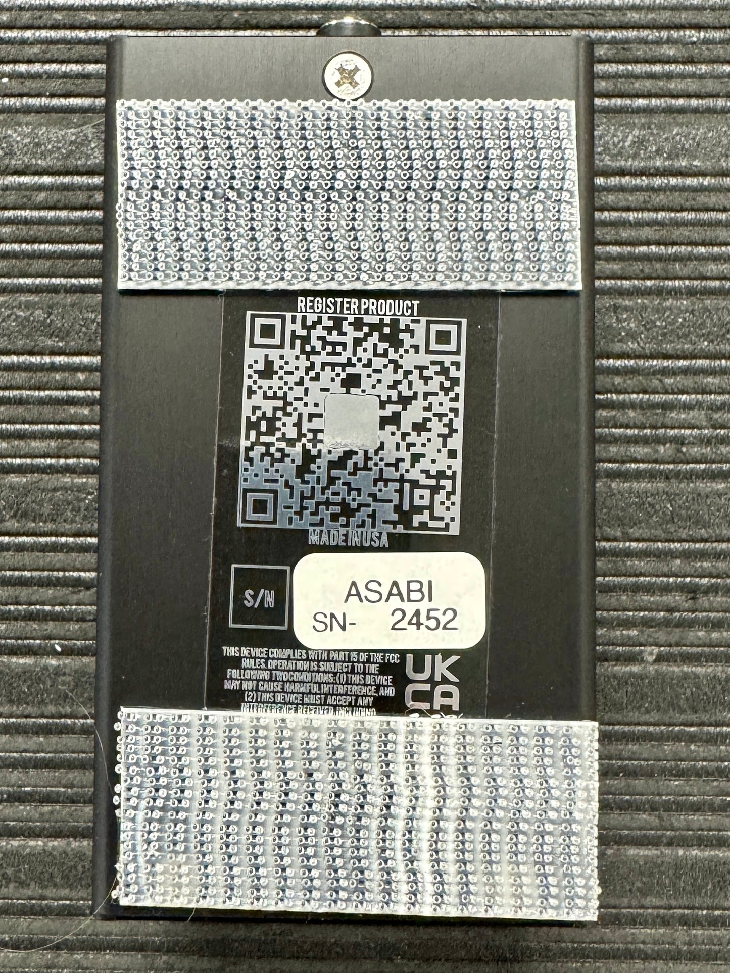 Product packaging with a QR code and text on a textured surface