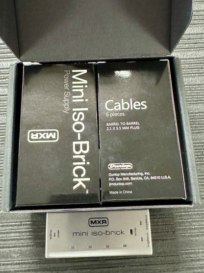 MXR mini iso-Brick power supply and cables packaging on a textured surface