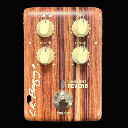 Wooden guitar effects pedal with knobs and labels on a textured background