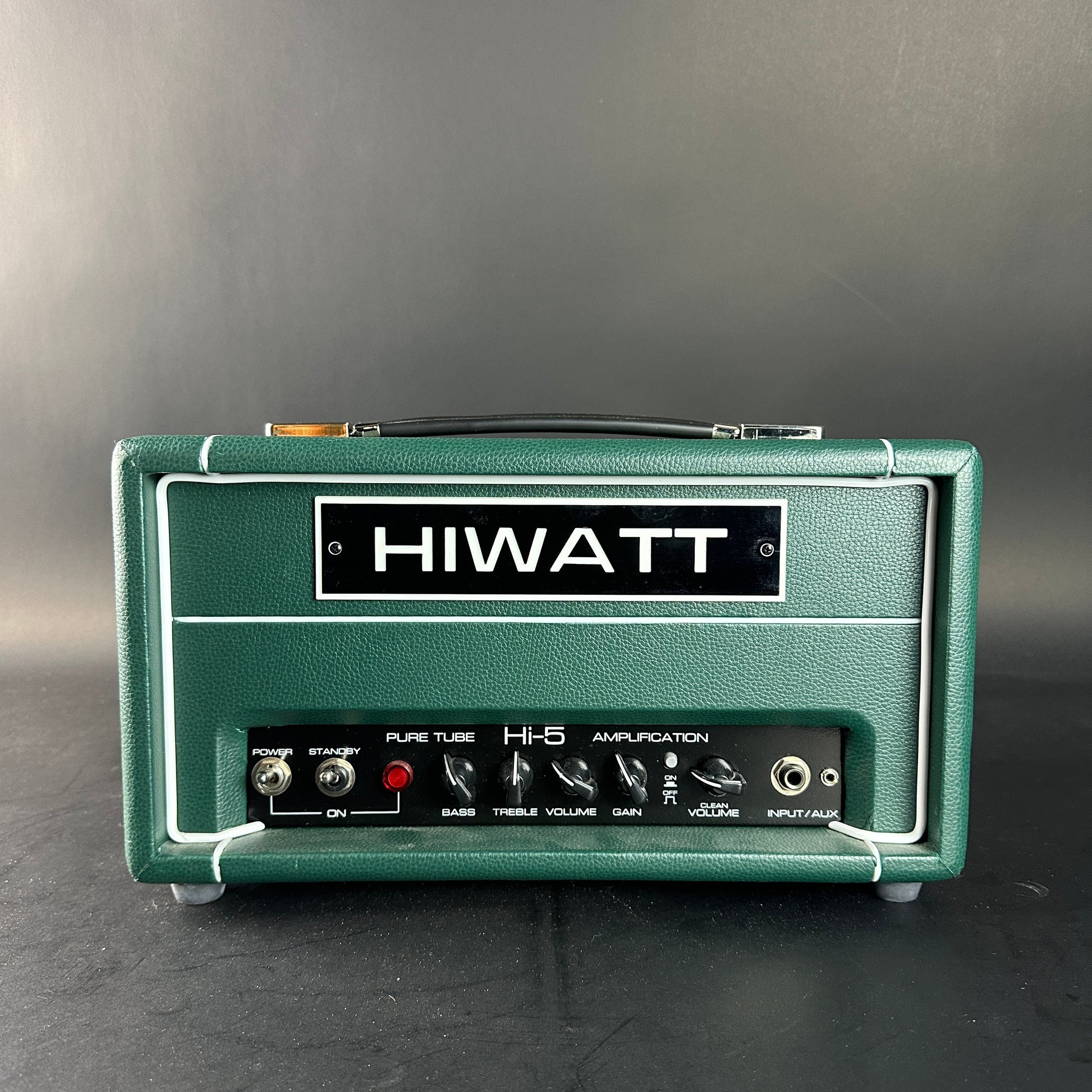Green Hiwatt amplifier head on a gray background