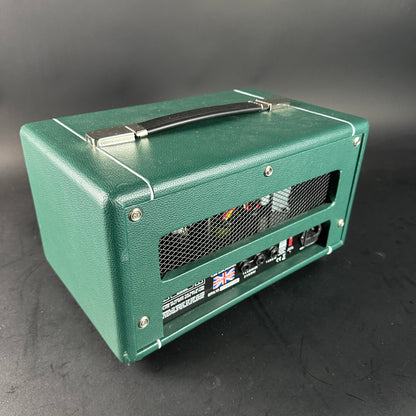 Green guitar amplifier on a gray background