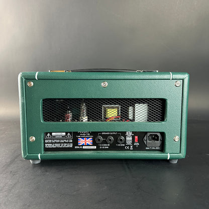 Green guitar amplifier on a gray background