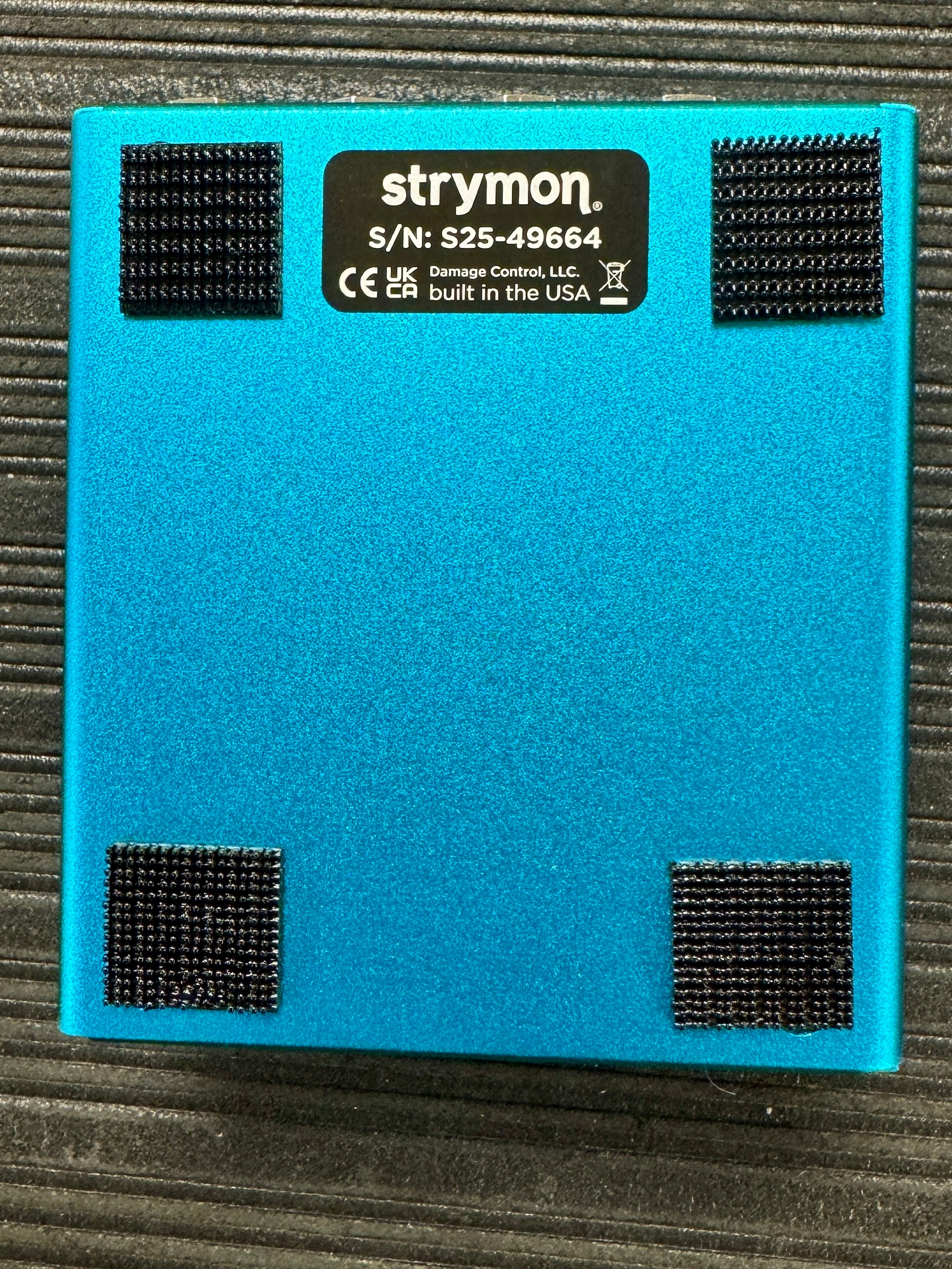 Blue electronic device with Strymon branding on a textured surface