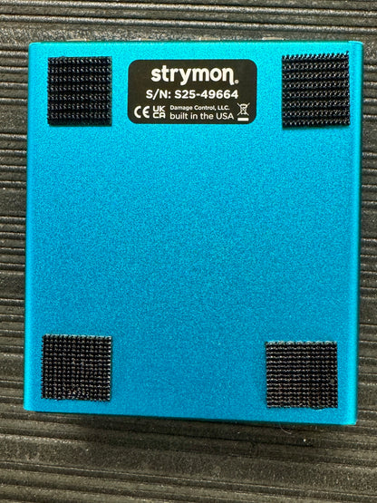 Blue electronic device with Strymon branding on a textured surface