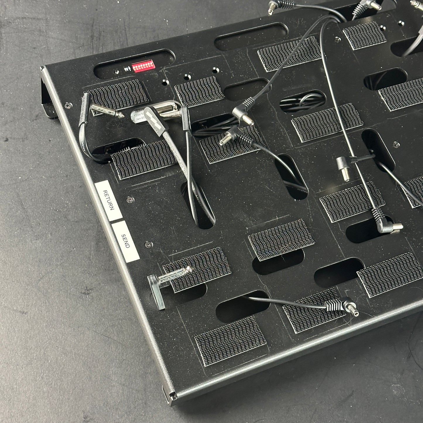 Close-up of a electronic component tray with various small parts on a gray surface