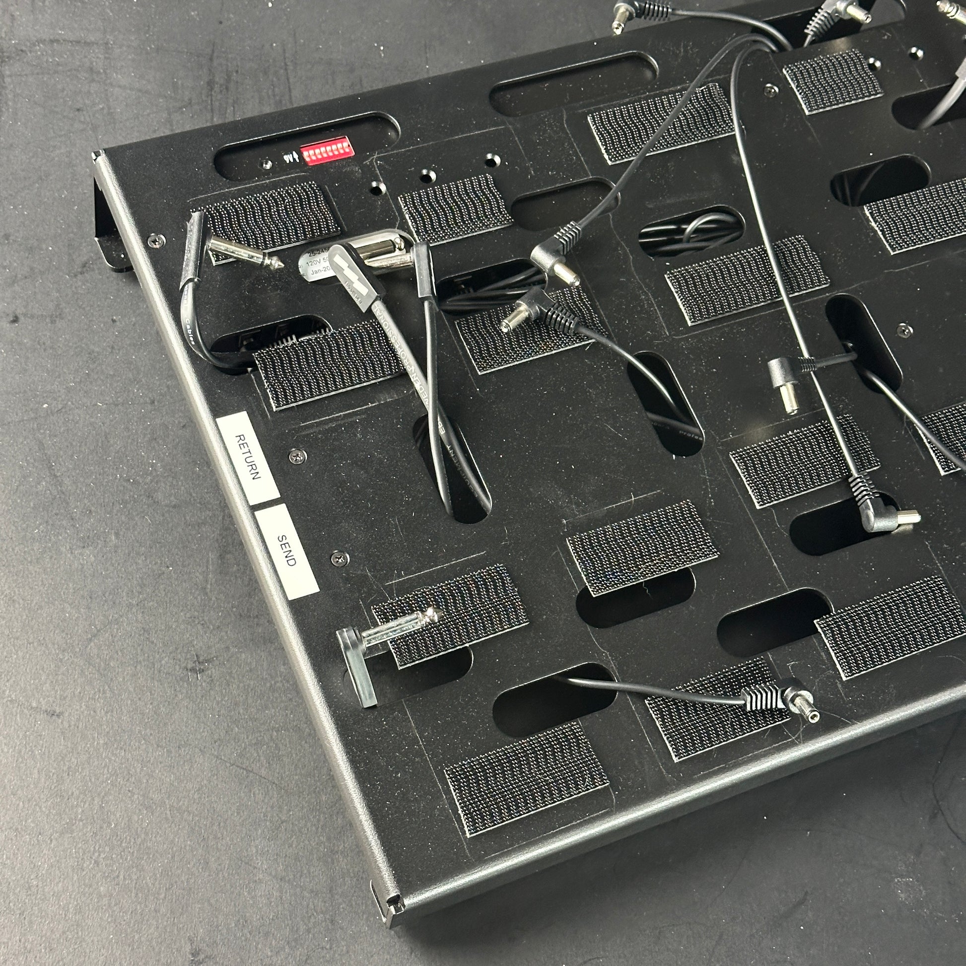 Close-up of a electronic component tray with various small parts on a gray surface