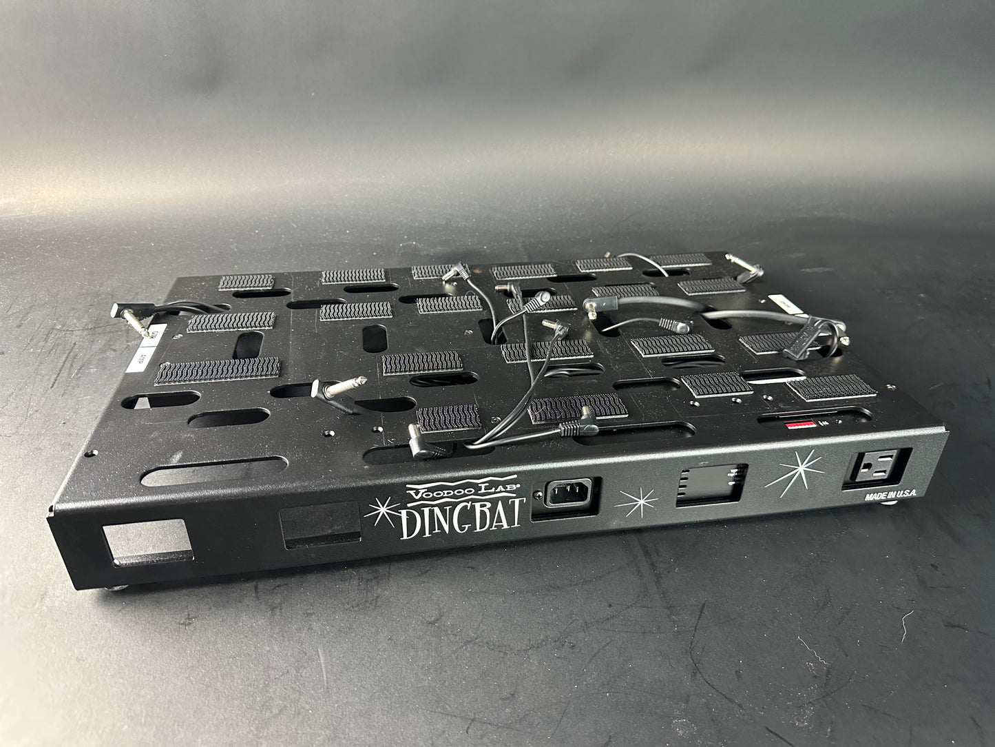 Black electronic device with 'Dingbat' branding on a gray background