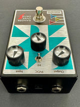 Guitar effects pedal with a geometric design on a gray background