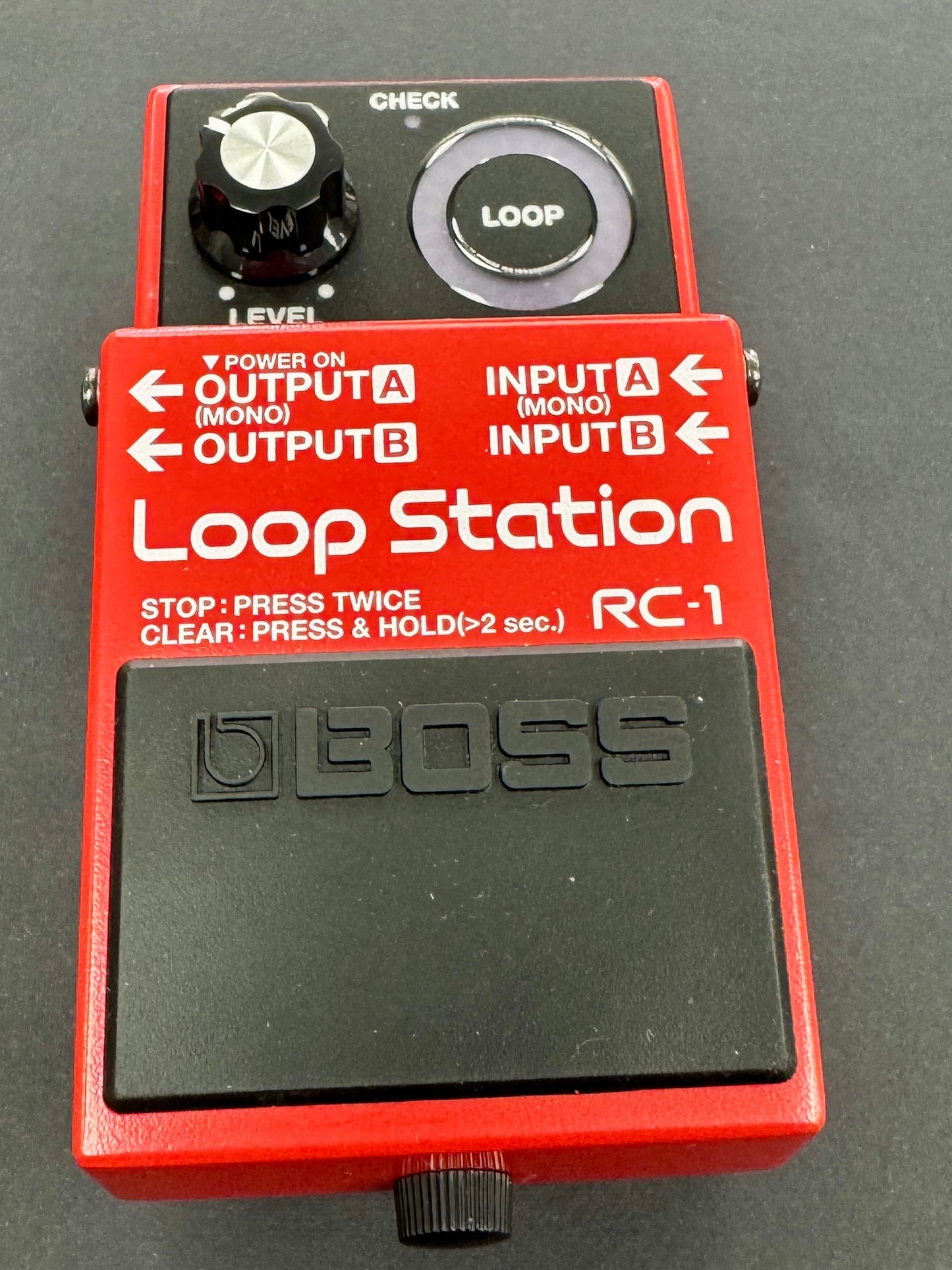 Red Loop Station RC-1 pedal with Boss logo on a dark background