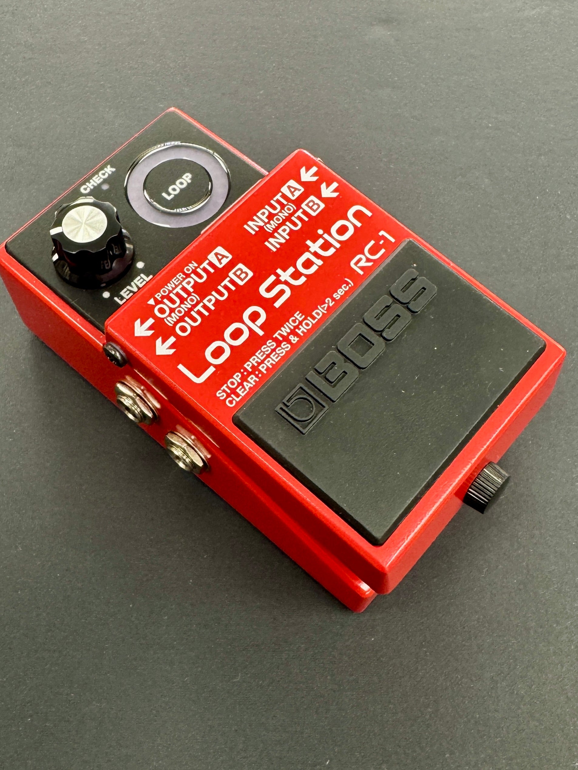 Red BOSS Loop Station RC-1 pedal on a gray background