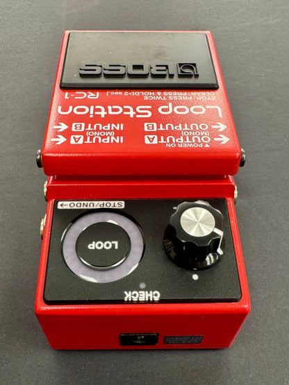 Red Boss Loop Station RC-1 guitar effects pedal on a gray background