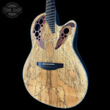 A custom acoustic-electric guitar with a natural wood grain body, featuring decorative inlaid wood pieces around the sound holes and a black pickguard, shown against a solid black background.