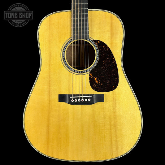 Acoustic guitar with a visible brand logo in the corner